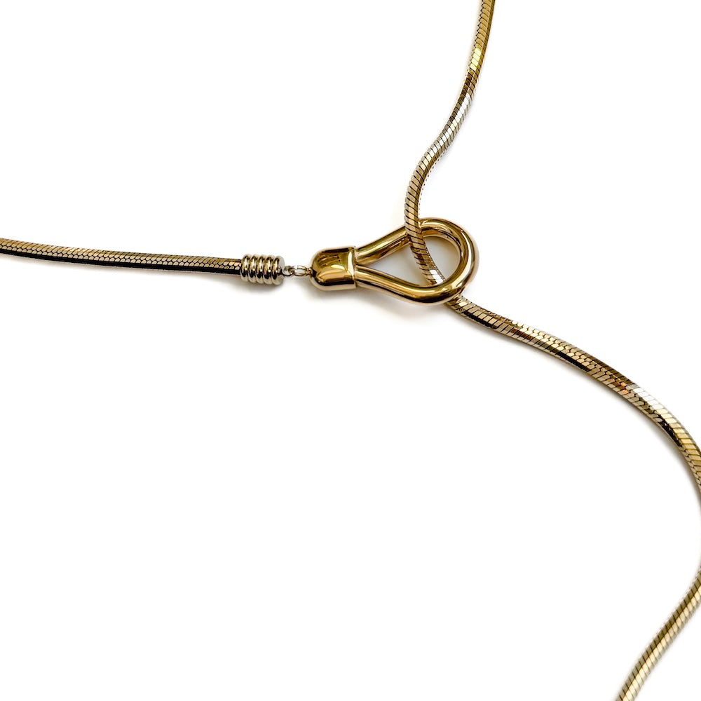 Close-up of gold-tone lariat toggle clasp with linked adjustable chain