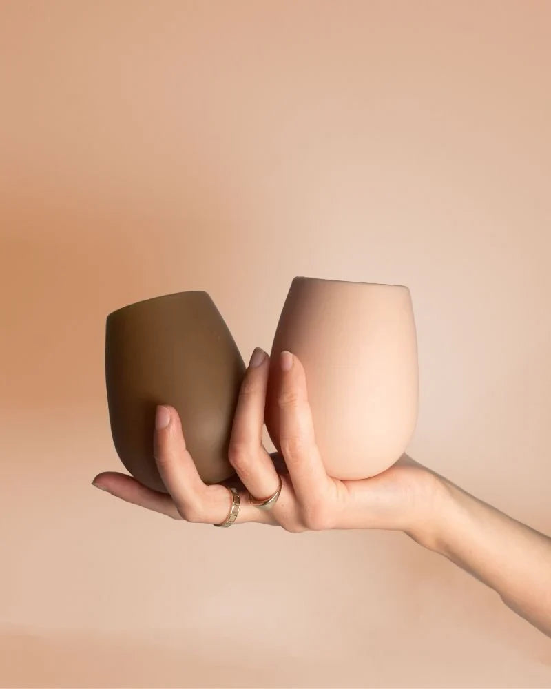 Dark and beige stemless silicone wine glasses, two cups with rounded rim and no stem