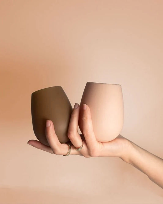 Dark and beige stemless silicone wine glasses, two cups with rounded rim and no stem