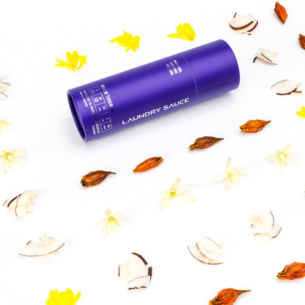 Purple cylinder laundry scent booster with Laundry Sauce label and dried botanicals