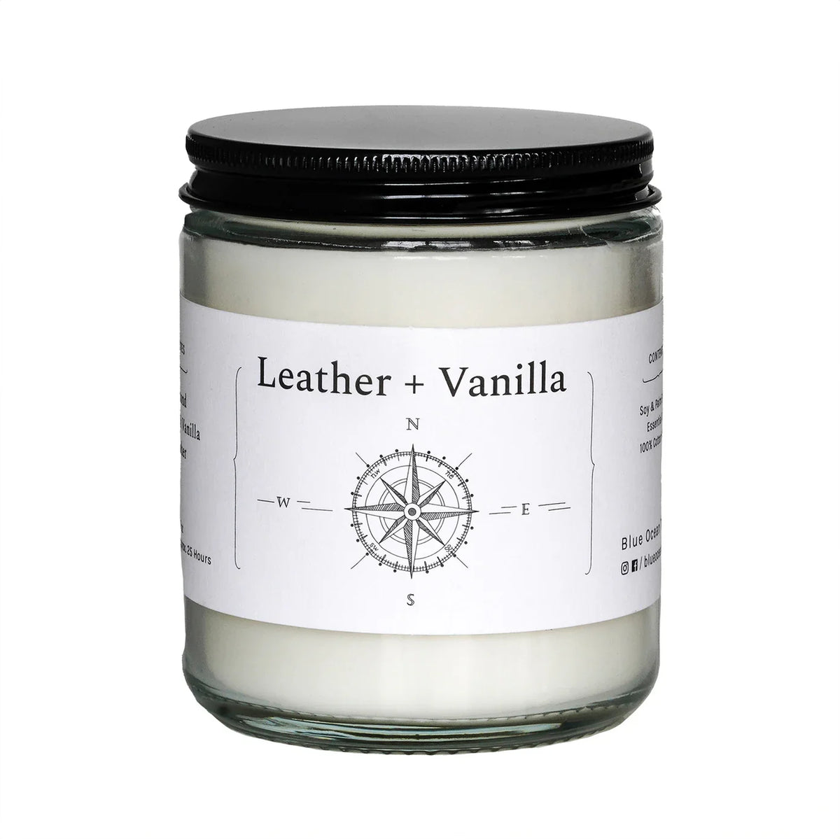 Leather + Vanilla jar candle in clear glass with black lid and compass label