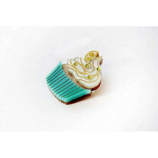 Lemon cupcake brooch with yellow swirl frosting and teal striped wrapper, gold-tone pin.