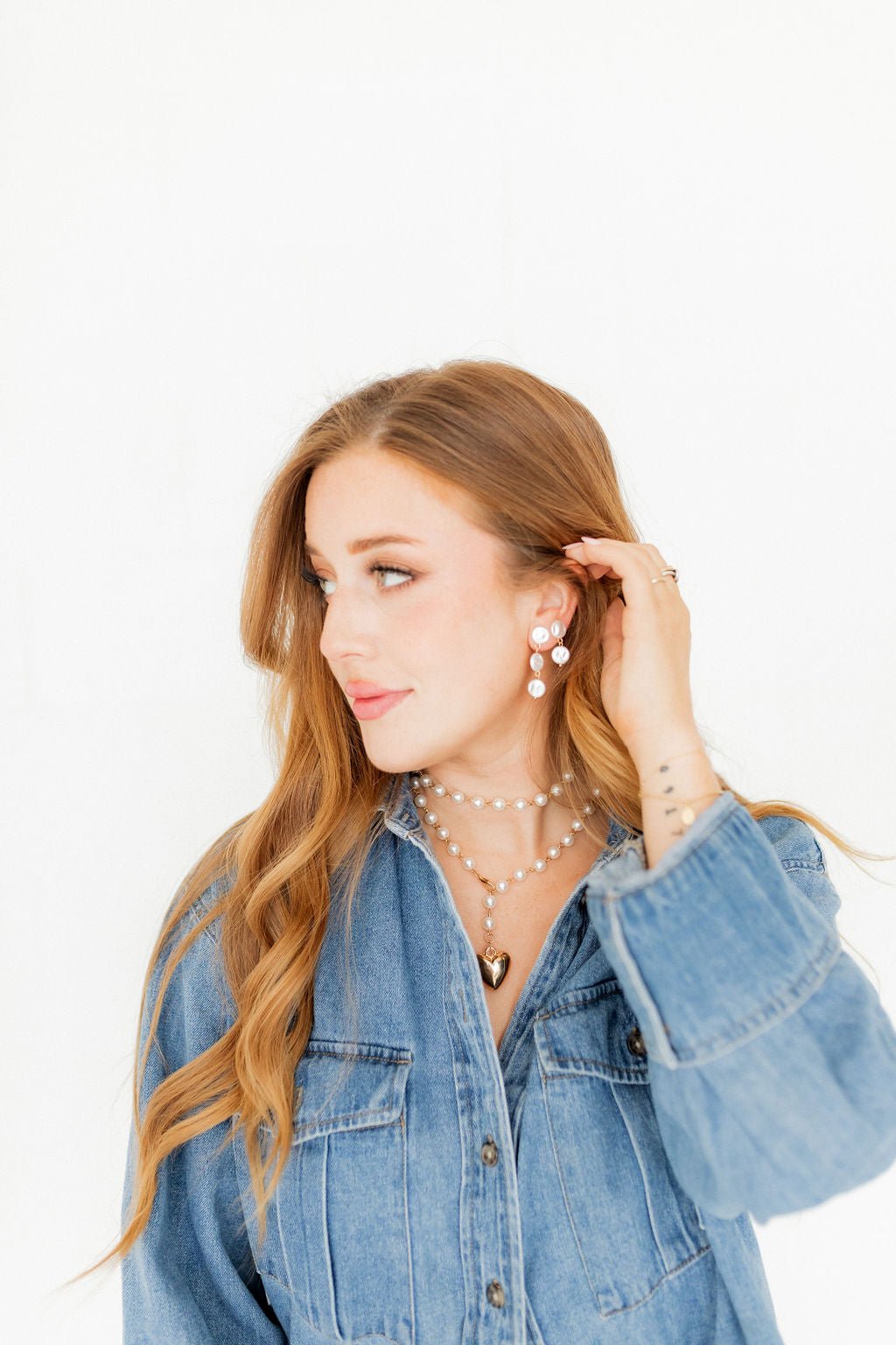 Pearl drop statement earrings with three white pearl discs and gold-toned hardware