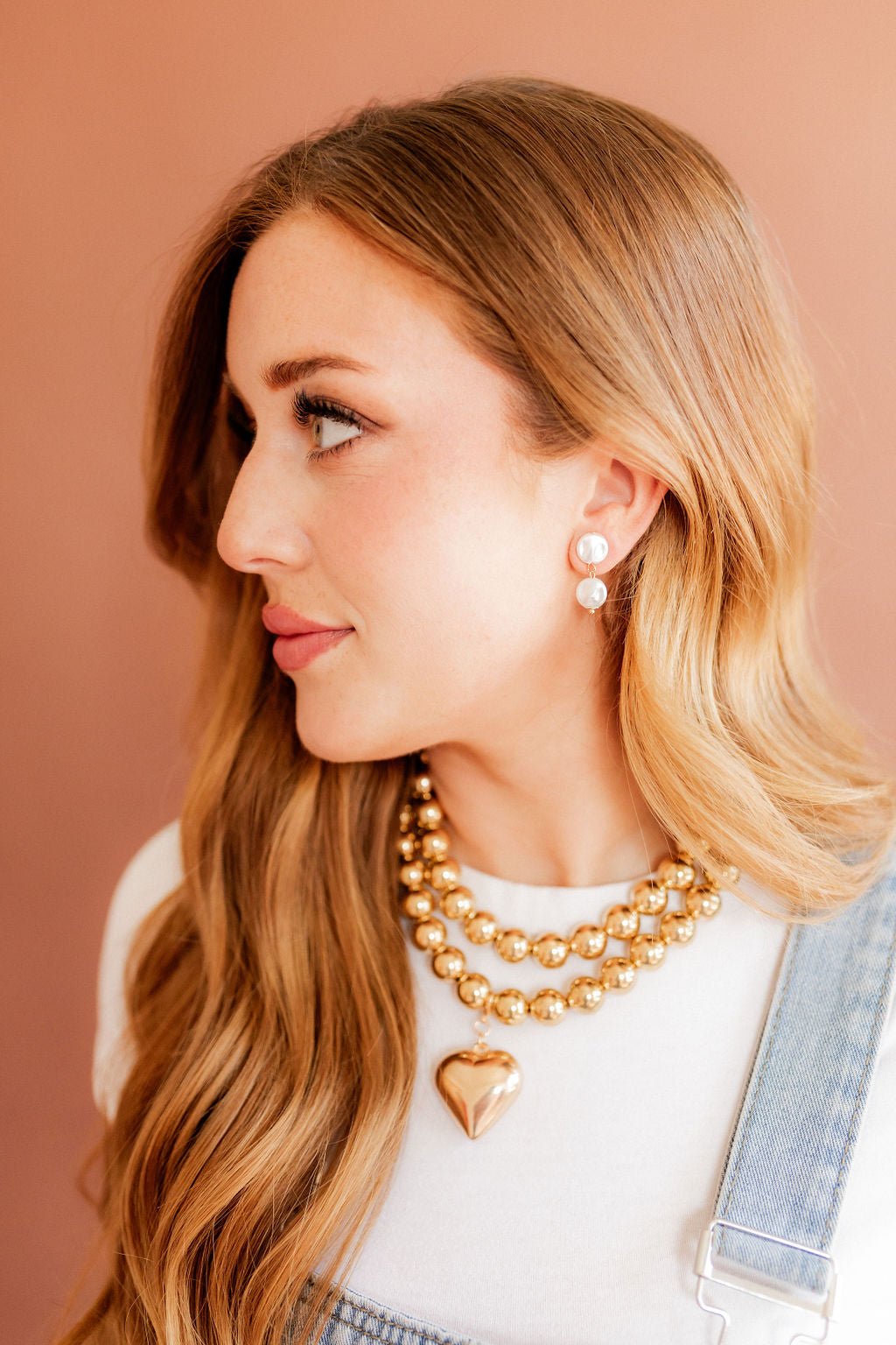 Pearl drop statement earrings with white pearl discs and gold-toned hardware
