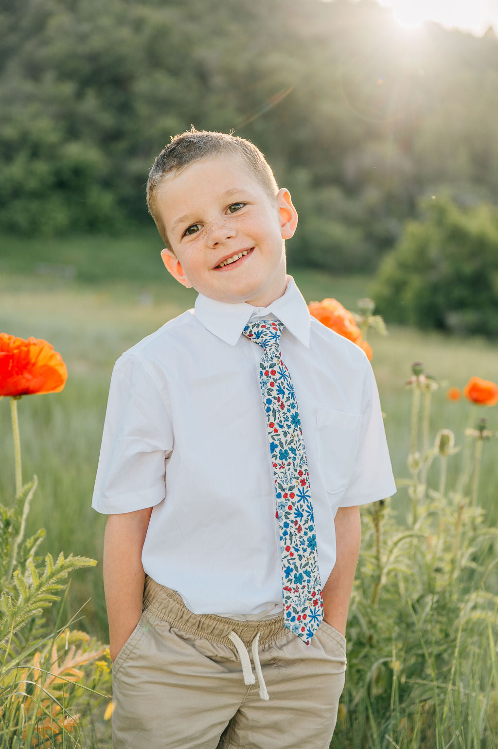 Boys floral necktie on a white shirt; blue, red, and green print