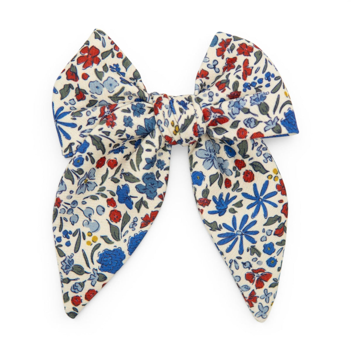Cream floral hair bow with blue, red, and green flower pattern