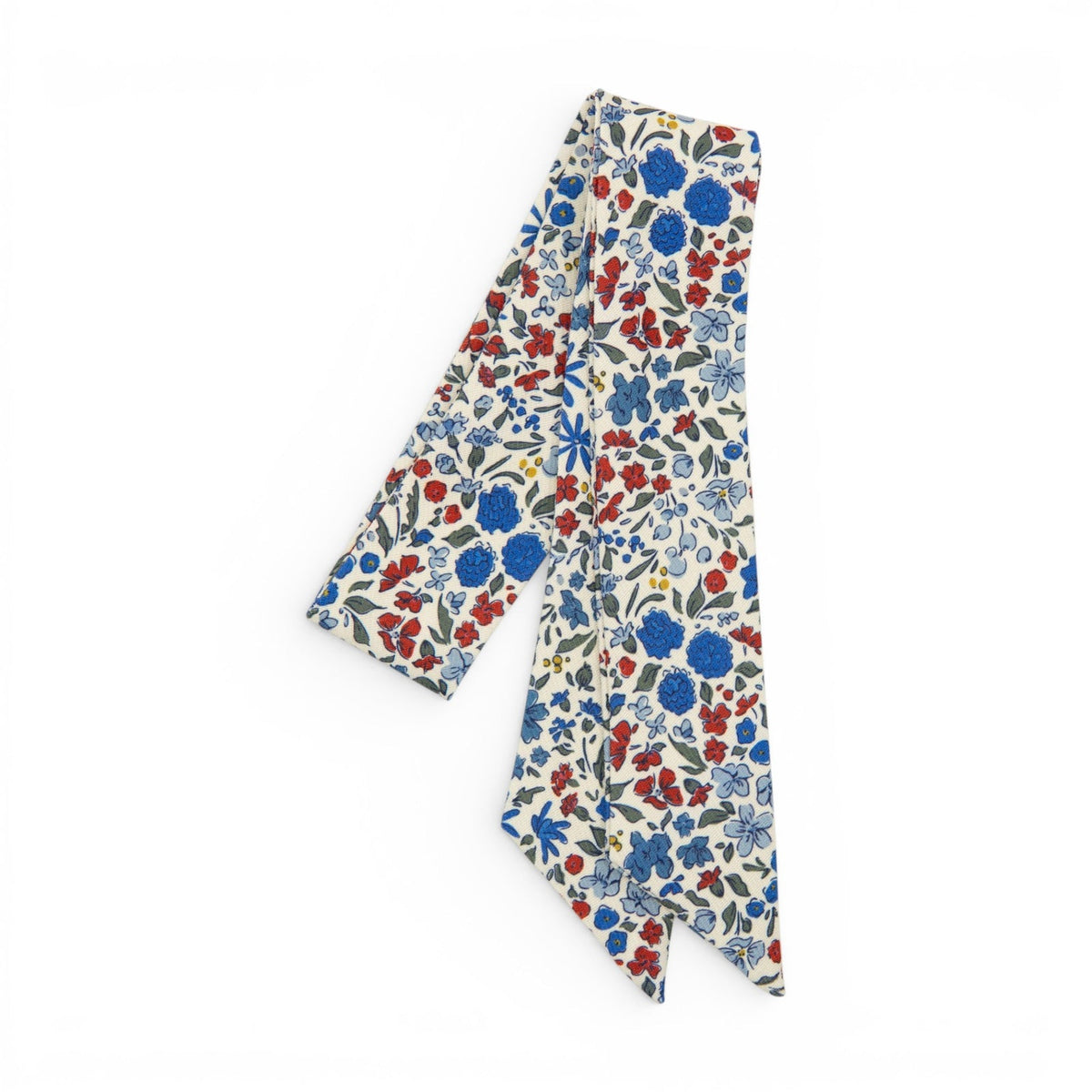 Floral hair sash with liberty-style blossoms on cream background, long ribbon ends