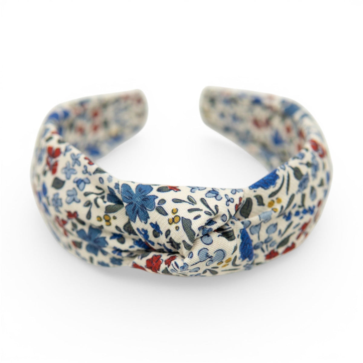 Floral knotted headband with blue, red, and green flowers on cream fabric