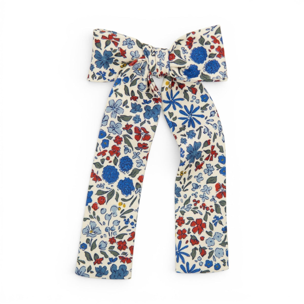 Floral lady hair bow with blue, red, and green blossoms on cream fabric