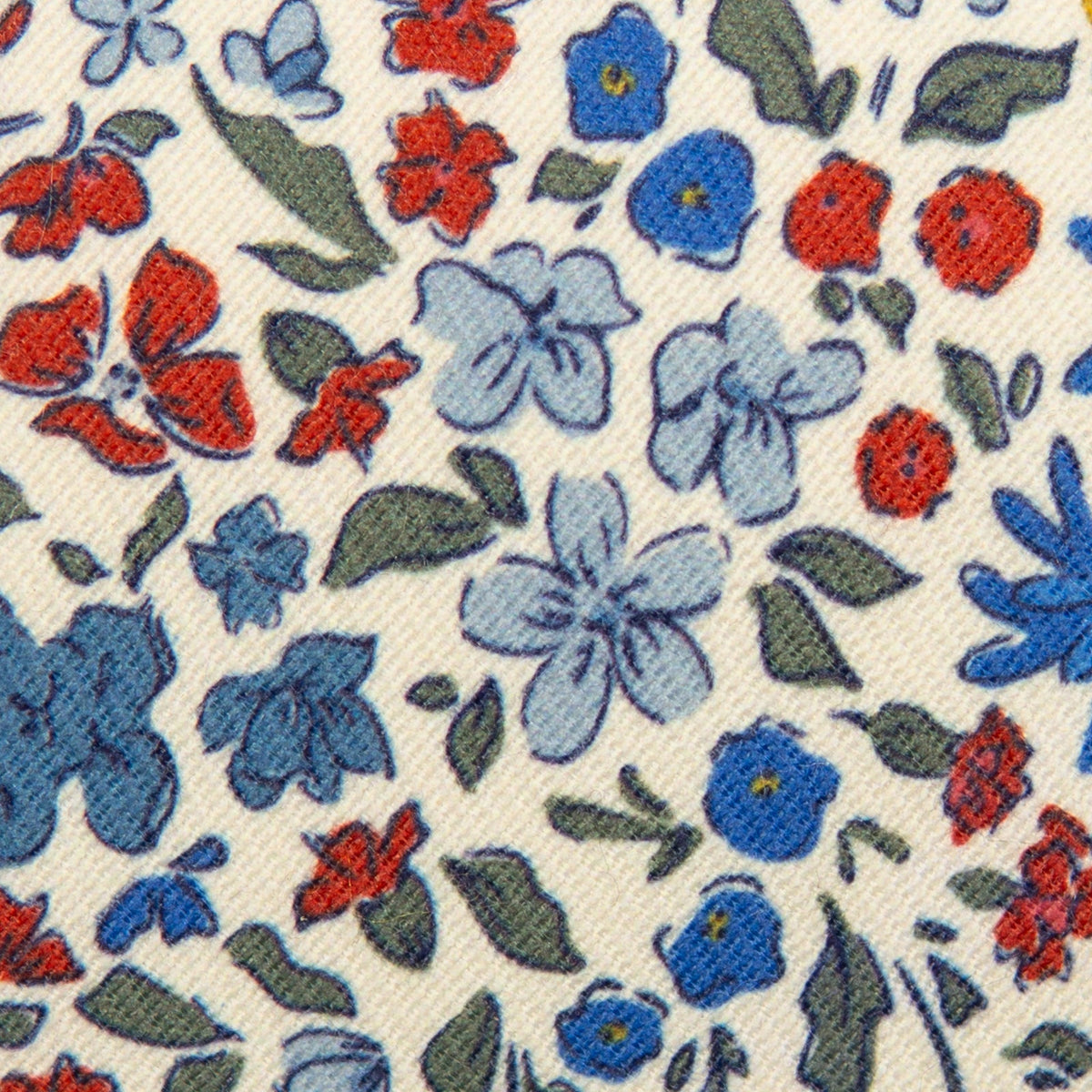 Youth floral necktie fabric closeup with blue, red, and green flowers on white