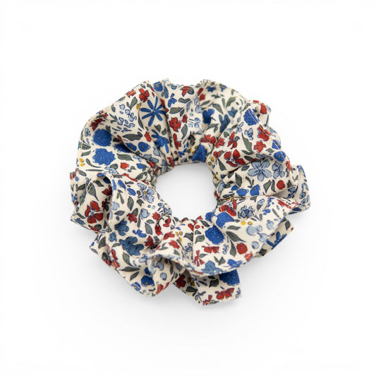 Floral fabric hair scrunchie with red, blue, and green small blossoms