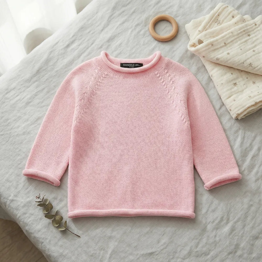 Pink knit baby rollneck sweater with ribbed trim and long sleeves