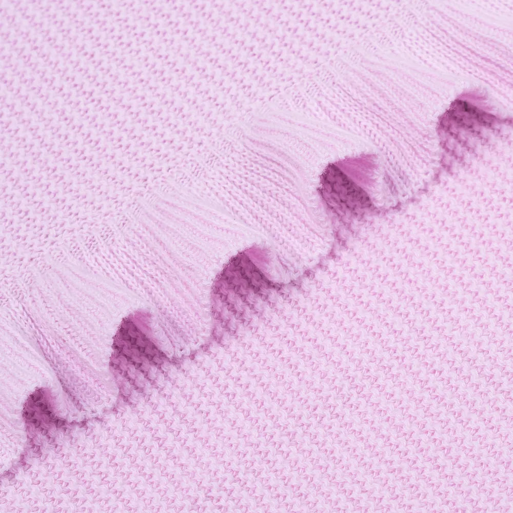 Lilac knitted baby blanket close-up with textured weave and ruffled trim