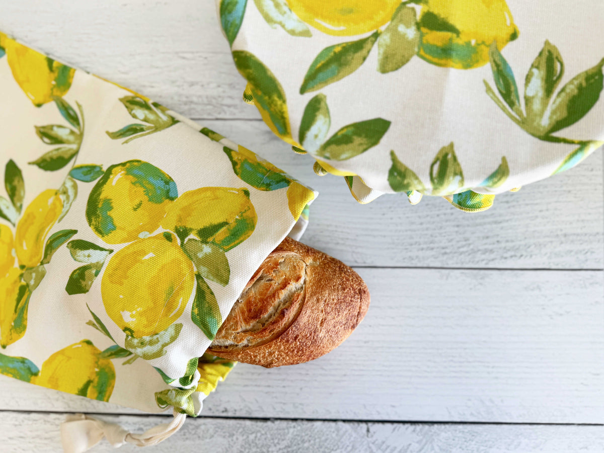 Lemon print bread bag and cover set, draped over a loaf