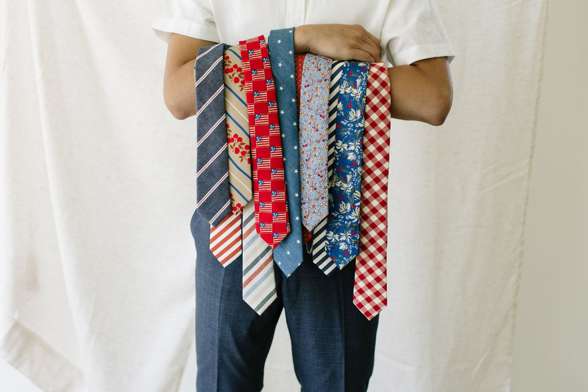 Bundle of men's ties featuring red-and-cream plaid with blue patterned accents