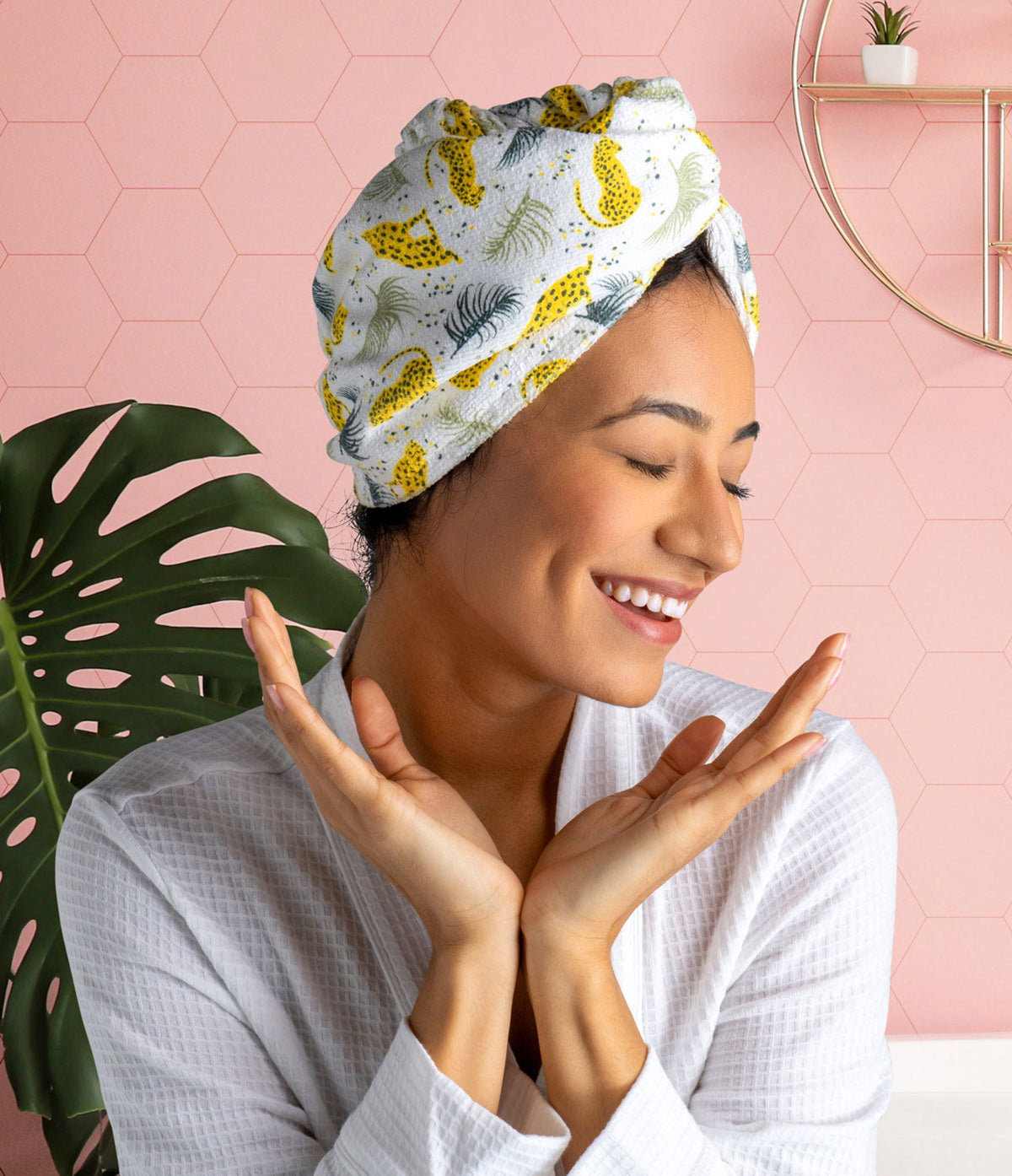 Tiger-print plot twist microfiber turbo towel worn as a head wrap, person smiling