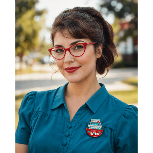 Nesting bowls heart brooch on teal shirt, red-and-white bird design