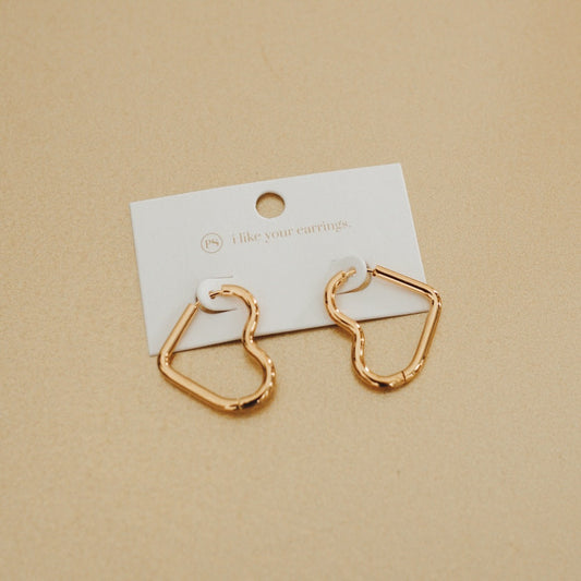 Gold-tone heart hoop earrings on a card with open heart silhouette.