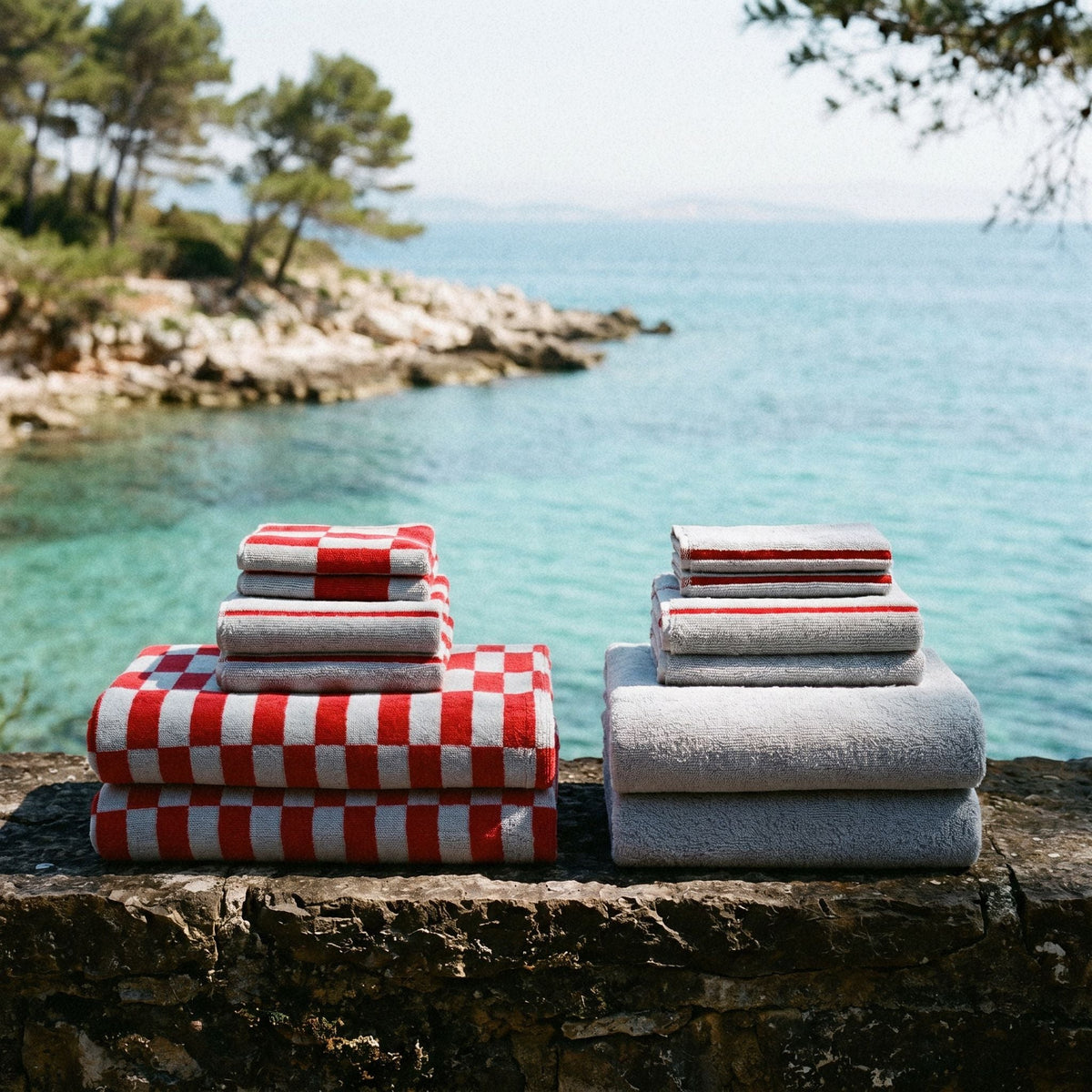 Gray towels with red-and-white check and stripe towel stacks, side-by-side