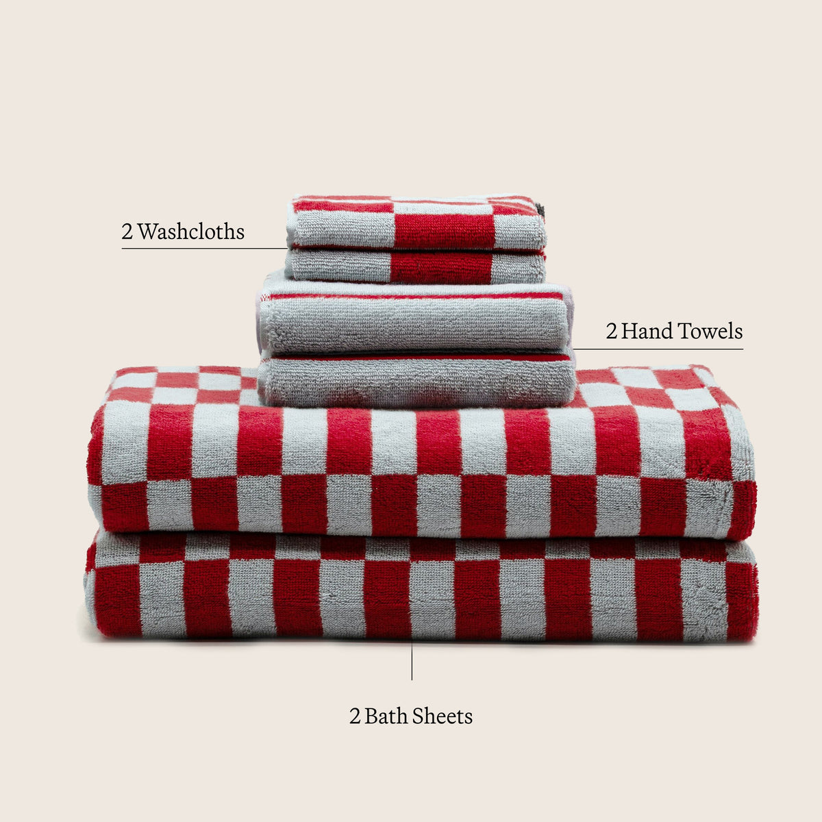 Red-and-white check bath towel with gray folded towels in stacked arrangement