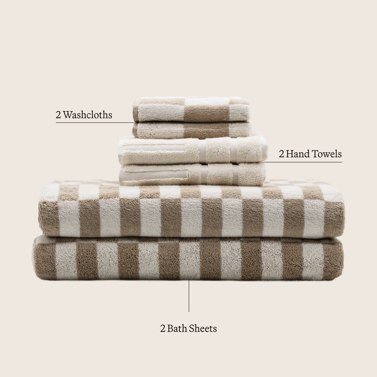 Tan and ecru cotton towels set with checkered stripes, folded on display