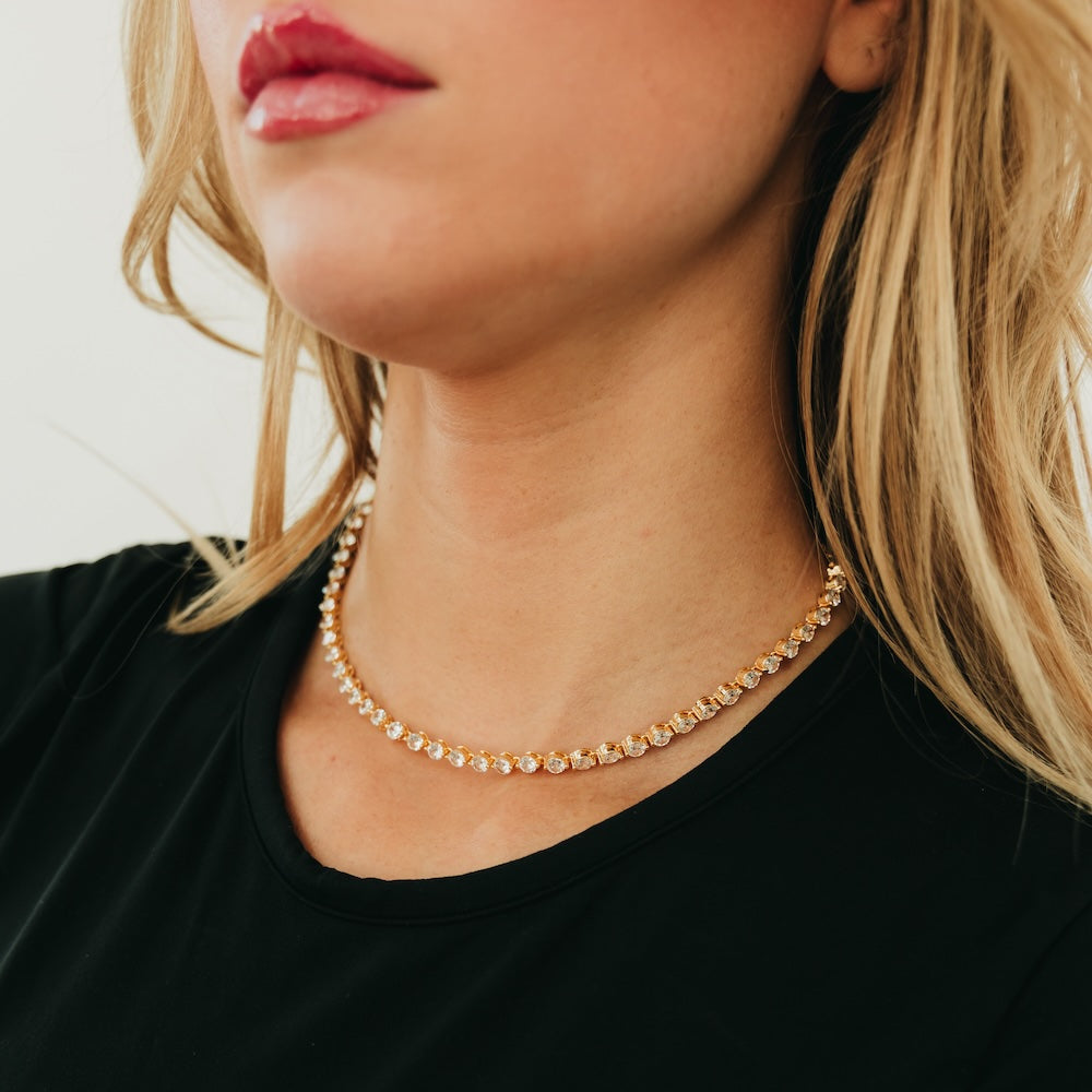 Gold-tone choker necklace with shimmering round rhinestone row
