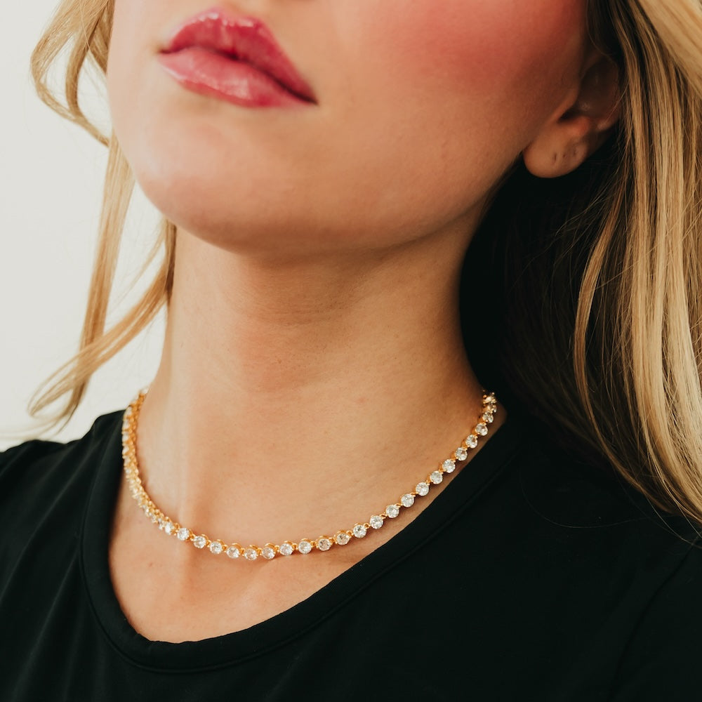 Gold-tone choker necklace with round clear rhinestone links