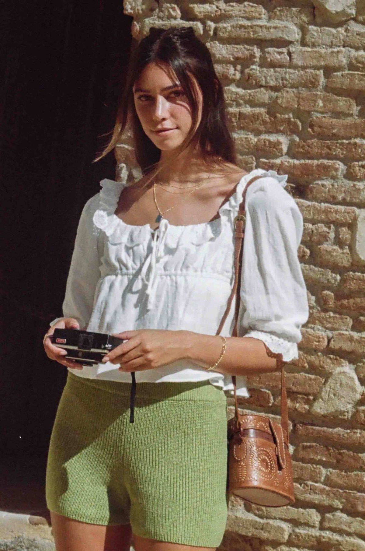 White cotton lace crop blouse with gathered bodice, puff sleeves, and lace trim edging