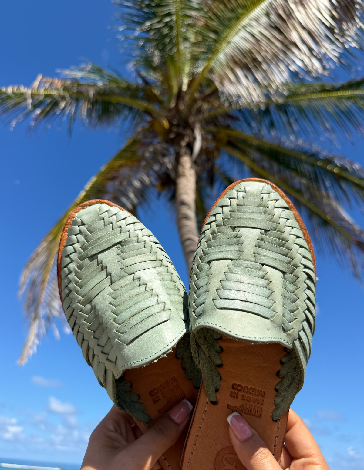 Teal woven slip-on huarache slide sandals showing patterned uppers and soles