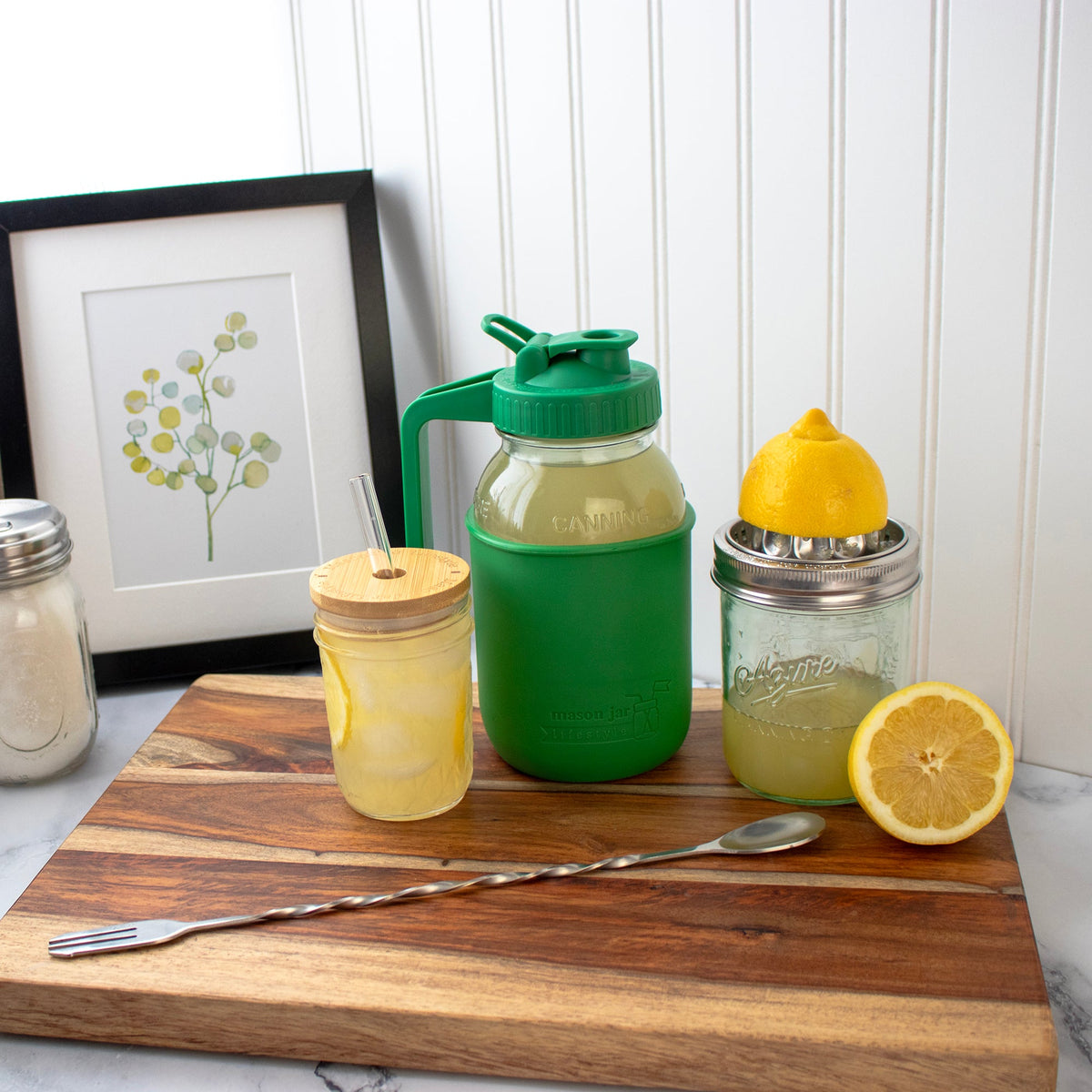 Stainless steel juicing lid shown beside wide-mouth mason jars and lemons