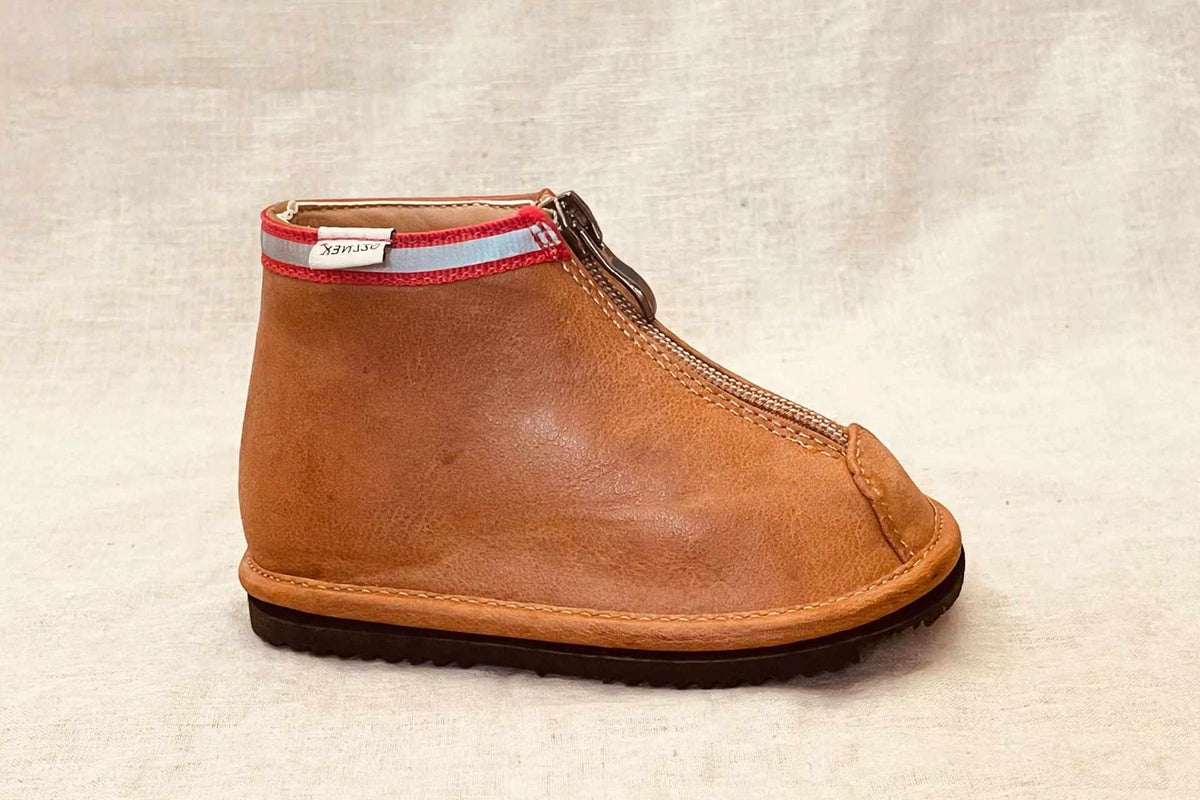 Single toddler brown ankle boot with side zipper and red collar trim, side view