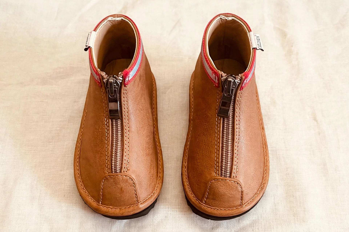 Toddler brown ankle boots, top view showing side zippers and red-lined collars
