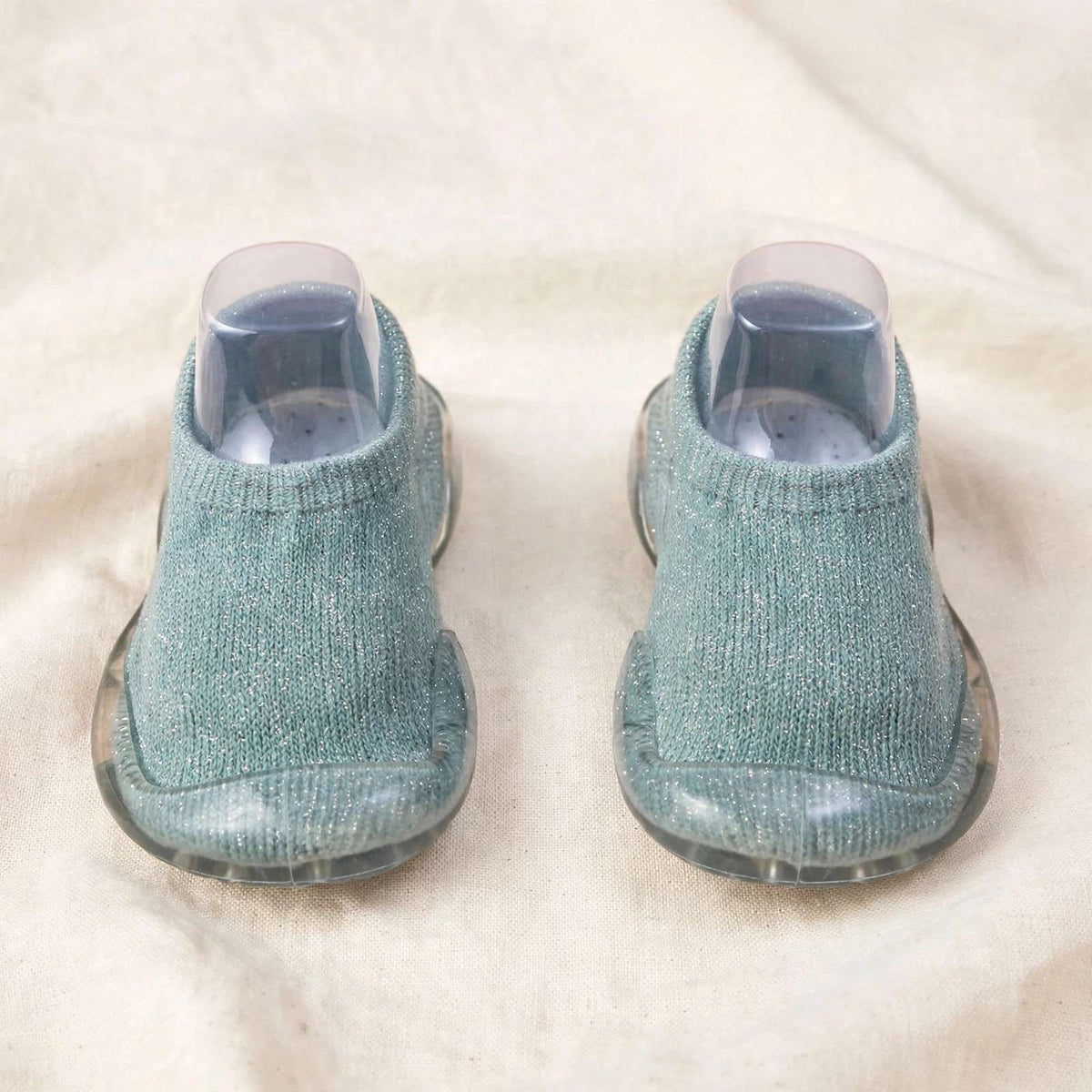Teal baby sock shoes with clear soles, back view with knit cuff