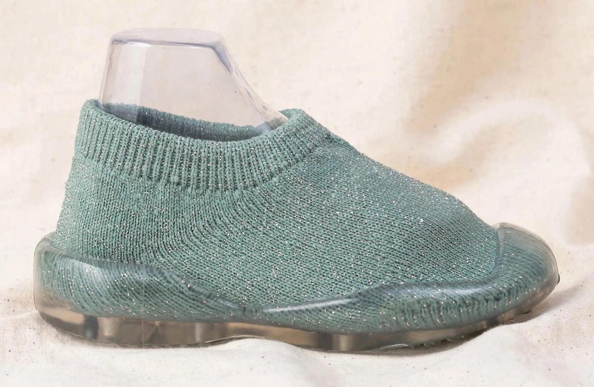 Teal baby sock shoe side view with clear sole and knit upper