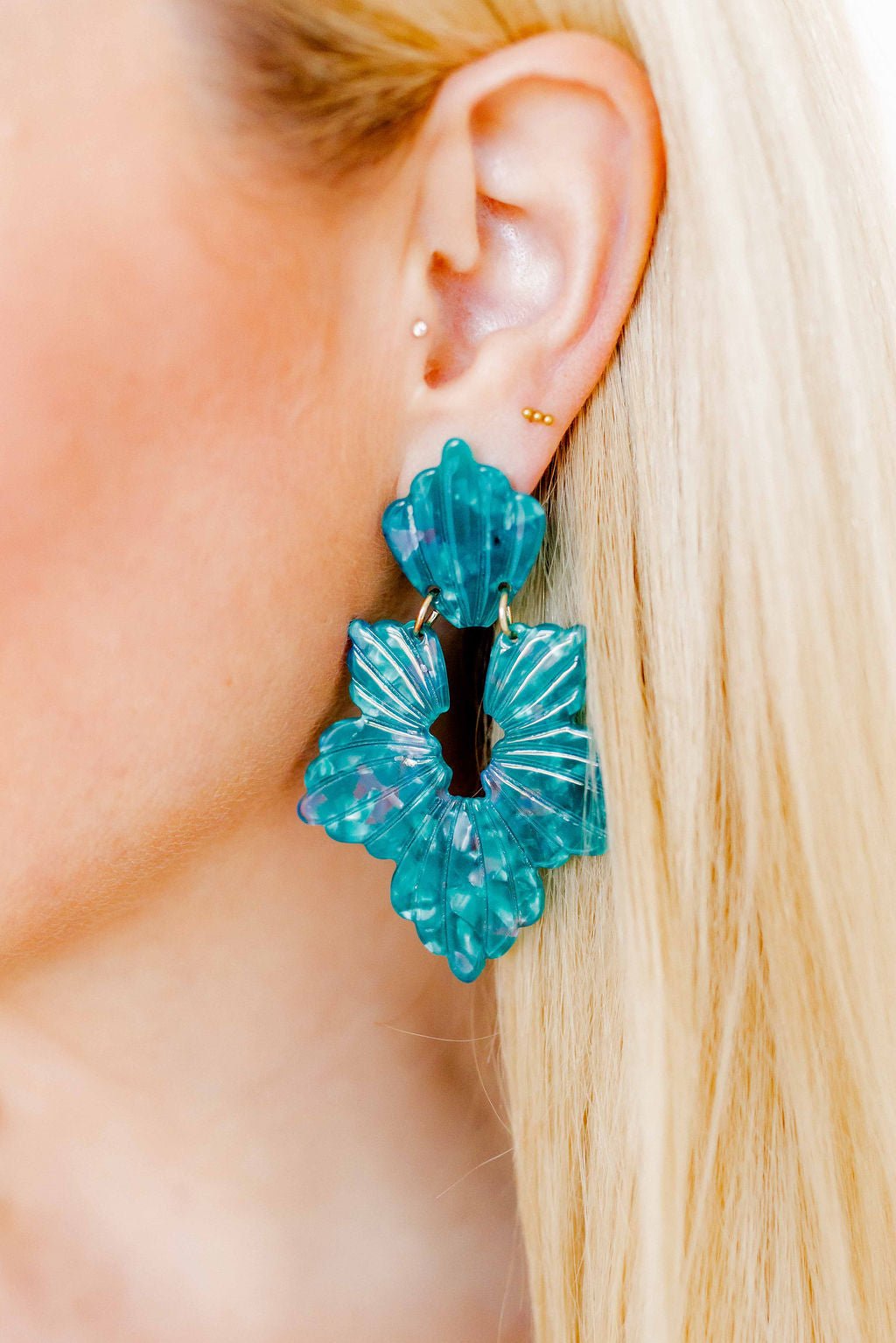 Turquoise floral statement earrings, close-up view of layered drop design