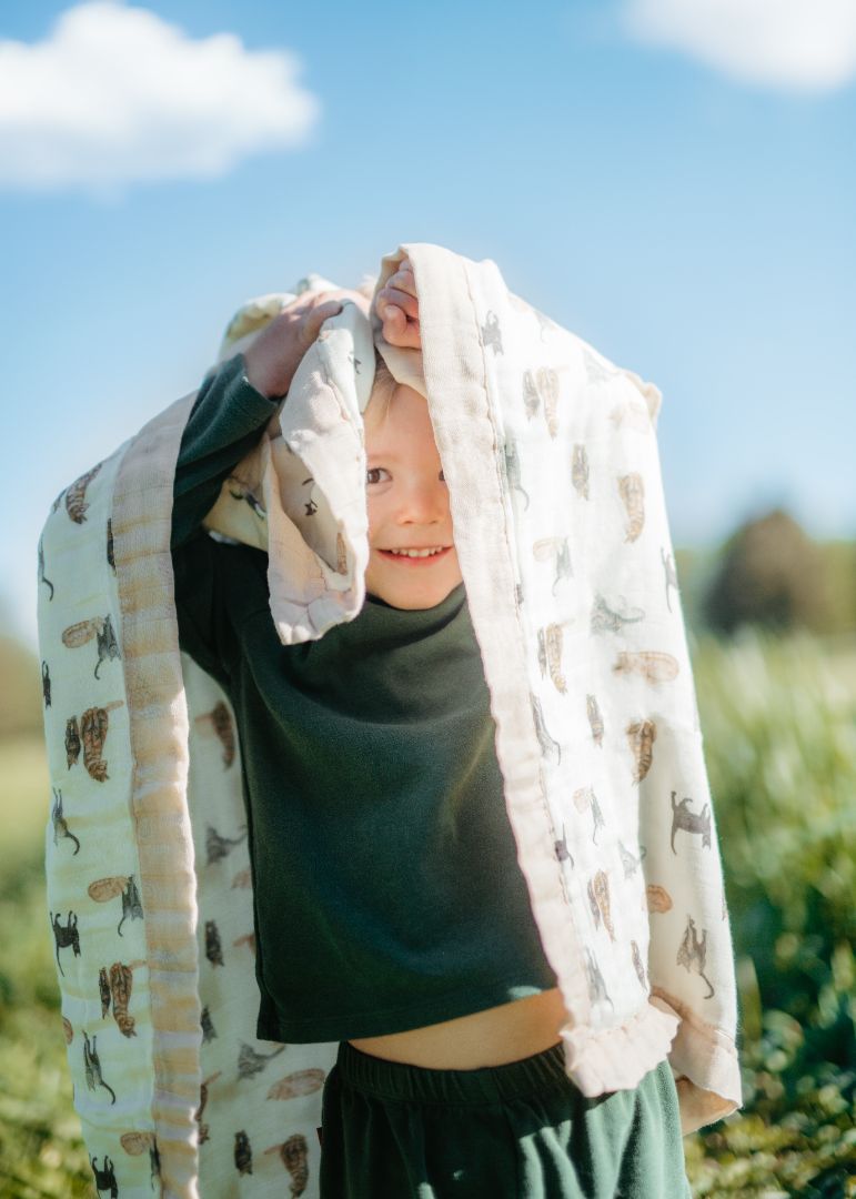 Teal koi fish baby lovey blanket draped over child