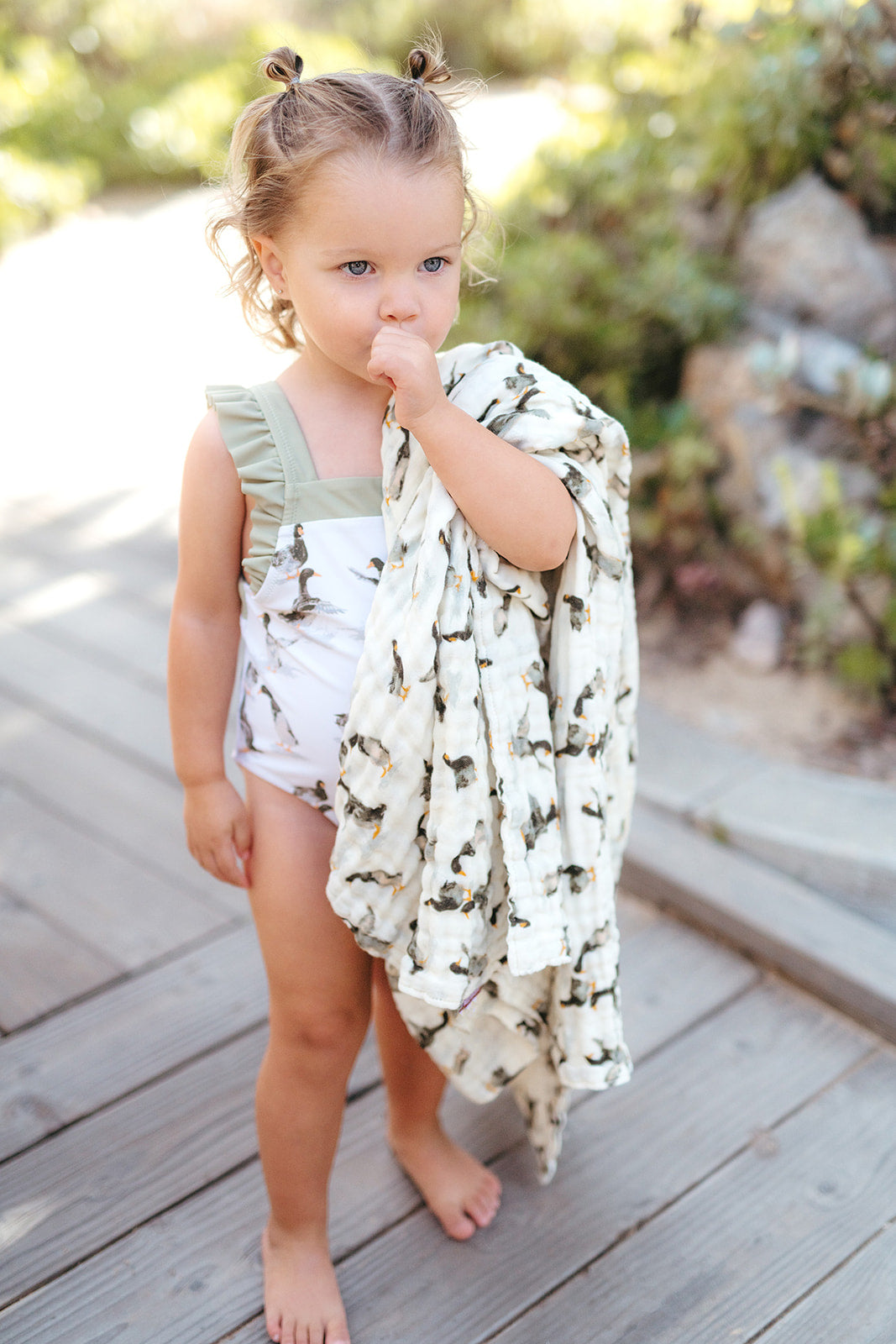 Strawberry print beach cover-up towel with ruffled neckline on a child