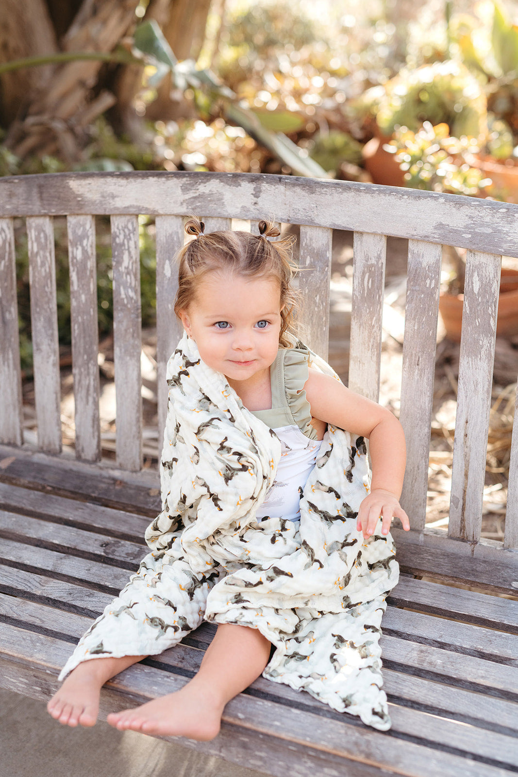 Strawberry print sleeveless beach cover-up towel with ruffled straps on a child