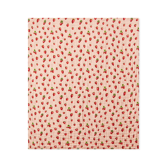 Peach strawberry print beach towel with red berries and green leaves, square folded