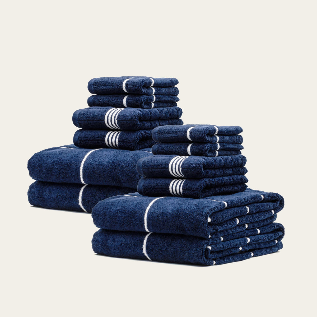 Miramar Australian cotton towels, navy with white stripe bands, multiple folded stacks