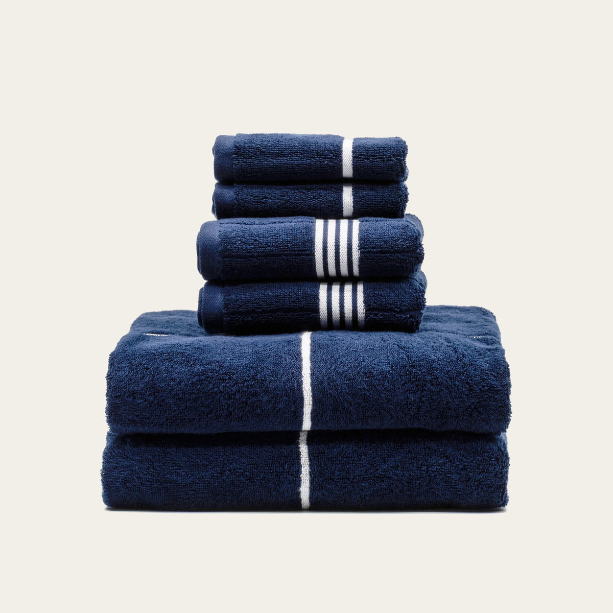 Miramar Australian cotton towels stacked, navy with white stripe bands, folded