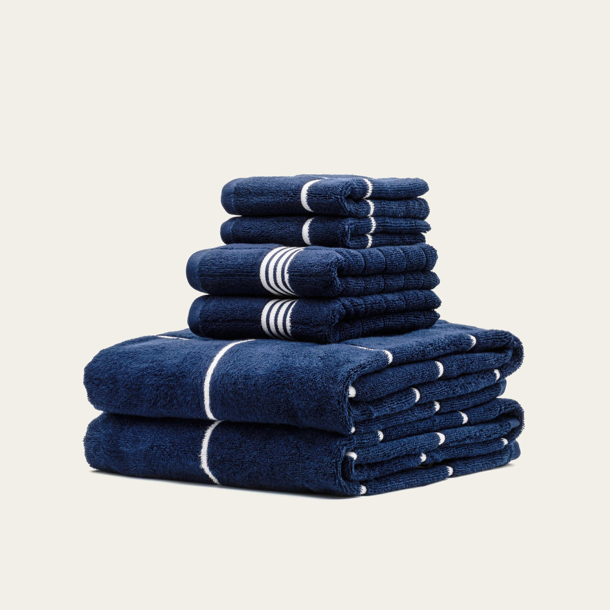 Miramar Australian cotton towels, navy with white stripe bands, stacked folded towels