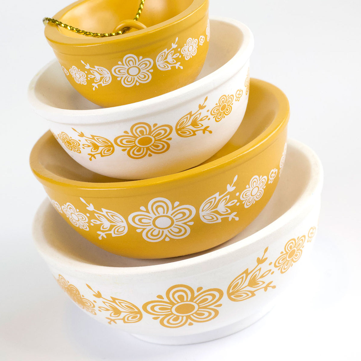 Mini Pyrex-inspired bowl ornaments, stacked white and yellow bowls with floral motifs