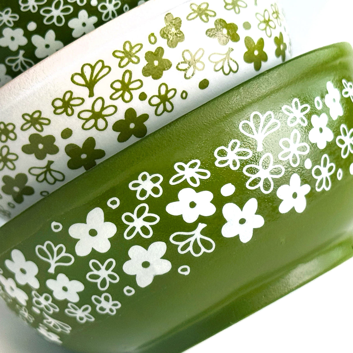 Mini Pyrex-inspired bowl ornament close-up in green with white four-leaf flower pattern
