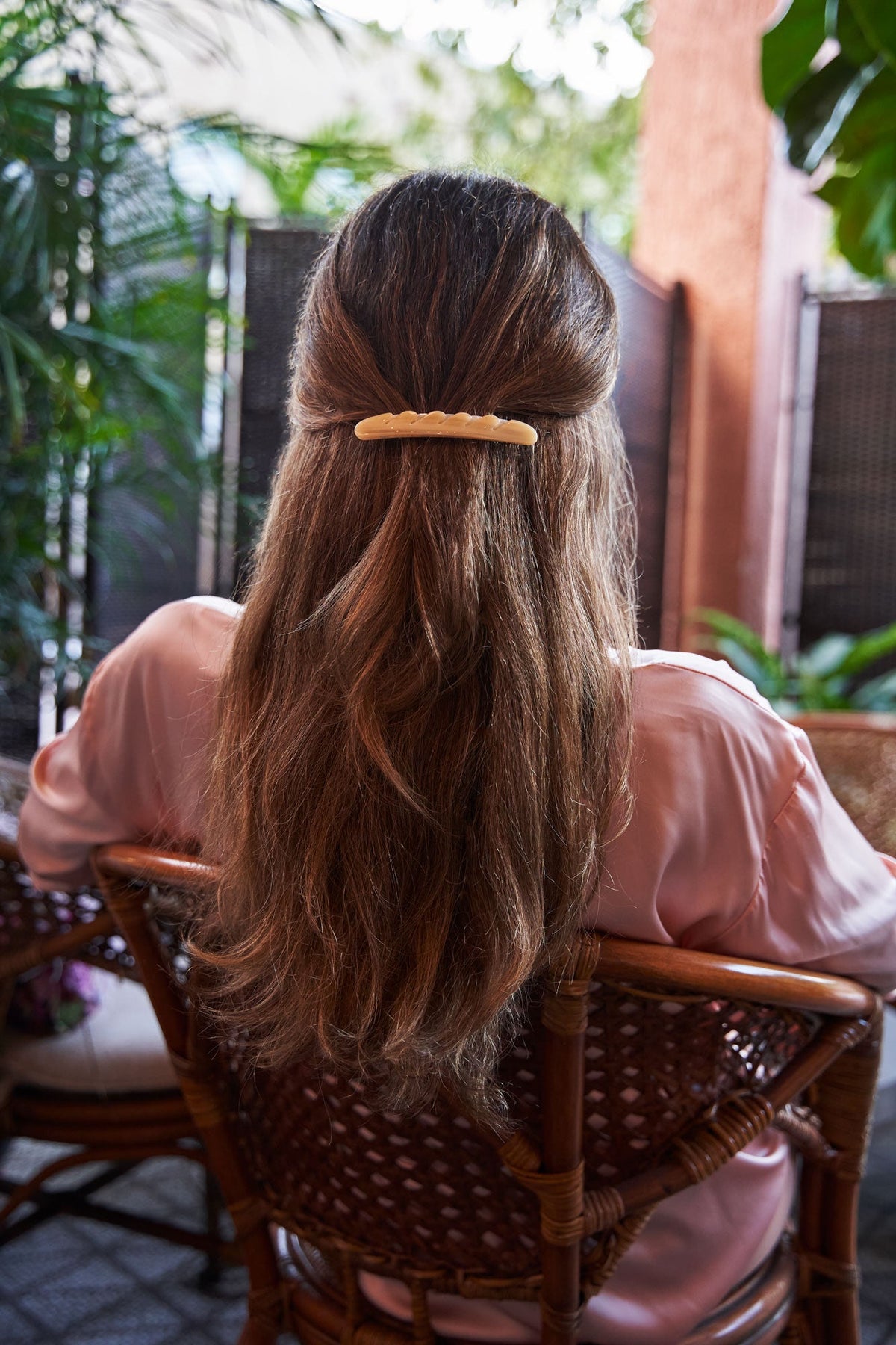 Cream baguette hair barrette clipped on long brown hair from the back