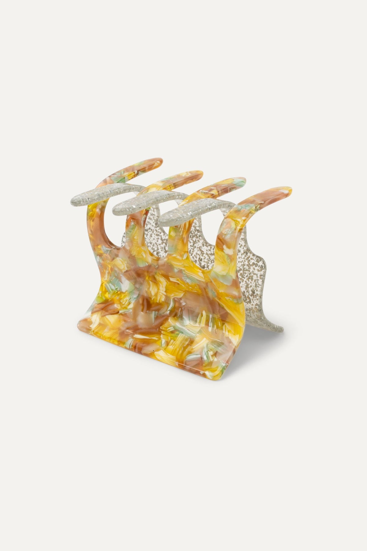 Decorative hair claw with four silver glitter prongs and translucent orange-gold resin