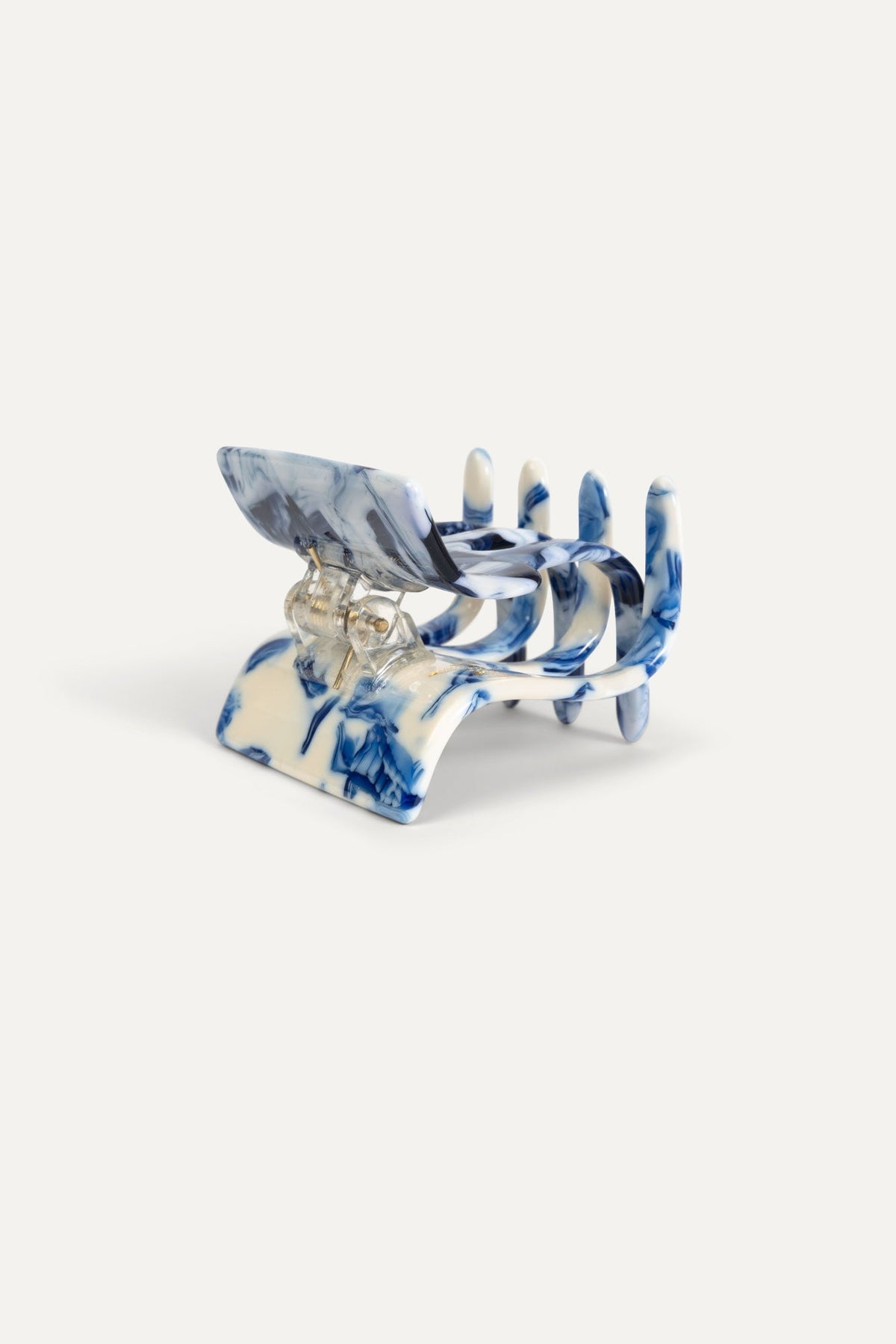 Mini marbled blue-and-white hair claw clip with transparent prong tips