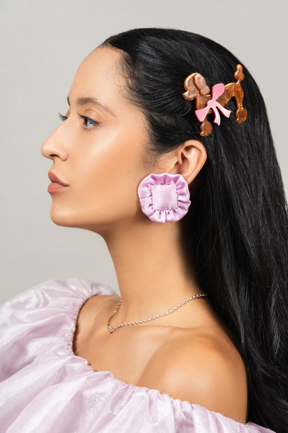 Poodle hair clip on hair: orange-brown dog face with pink bow pieces