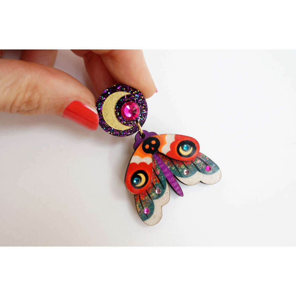 Moth drop earrings with orange patterned wings and glitter purple spiral caps, gold hooks