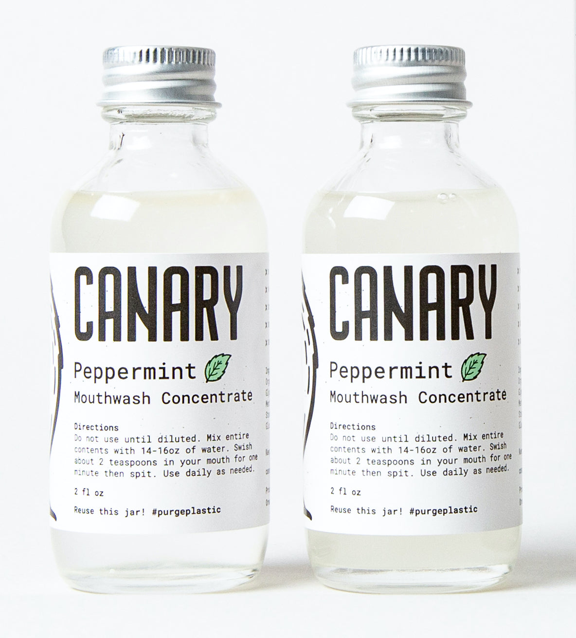 Two bottles of Canary peppermint mouthwash concentrate side by side
